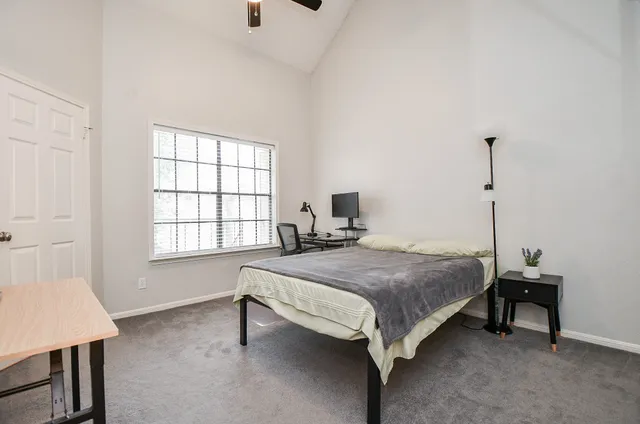 a bedroom with a bed and a television