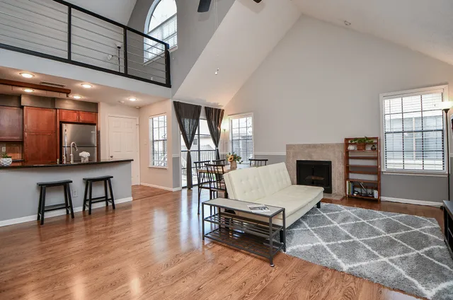 a living room with furniture a fireplace and a flat screen tv