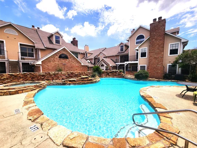 a swimming pool with outdoor seating
