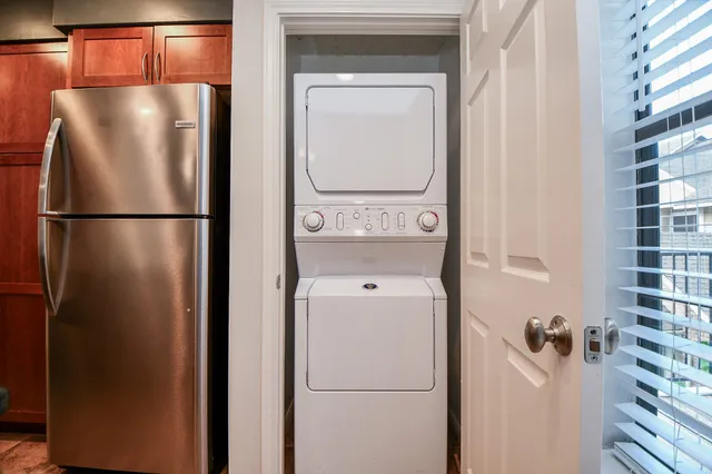 a white refrigerator freezer and a stove sitting inside of a kitchen