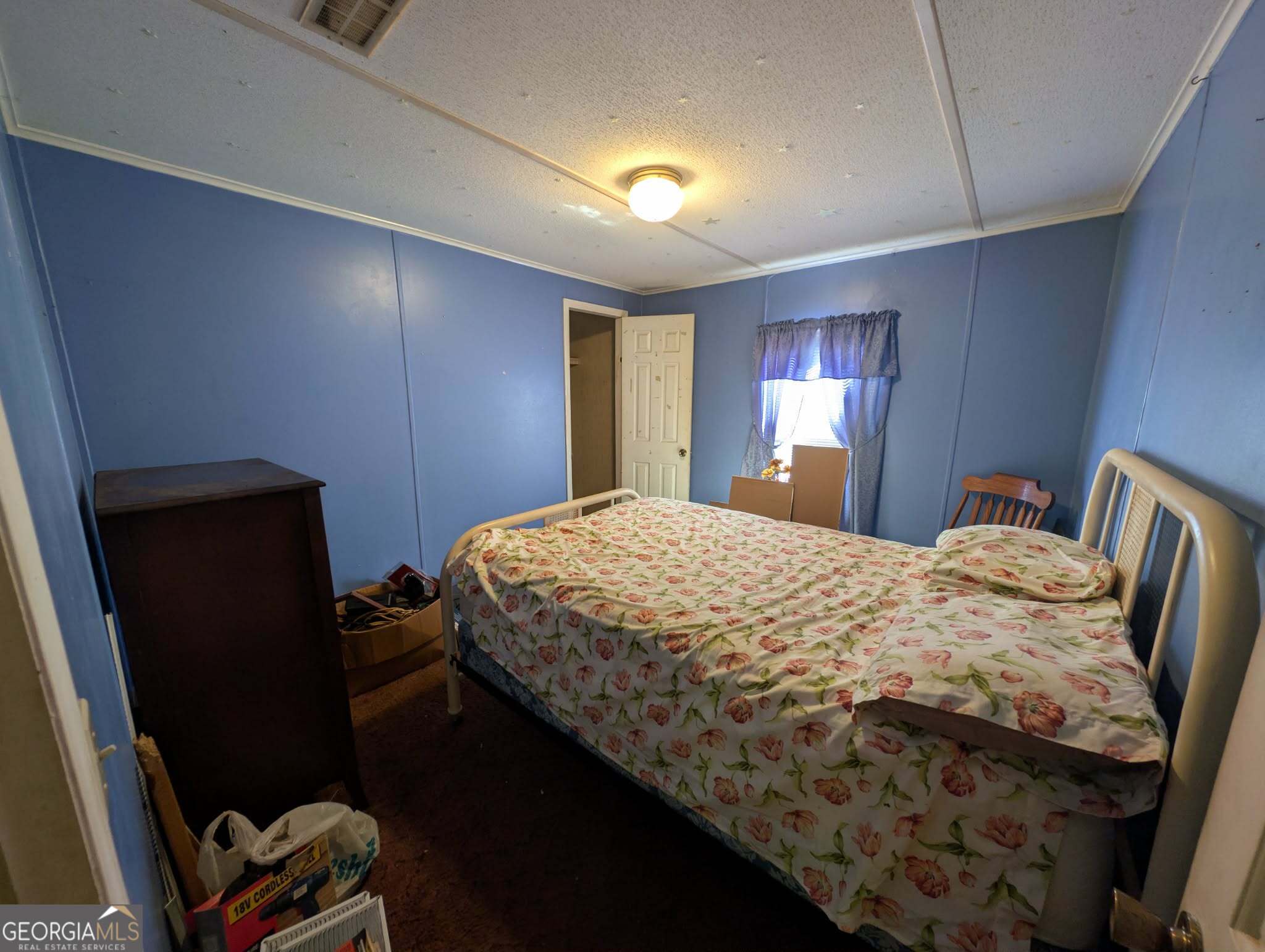 460 Etheridge Mill Road Milner, GA 30257 - Photo 14 of 27 a bedroom with a bed and a window