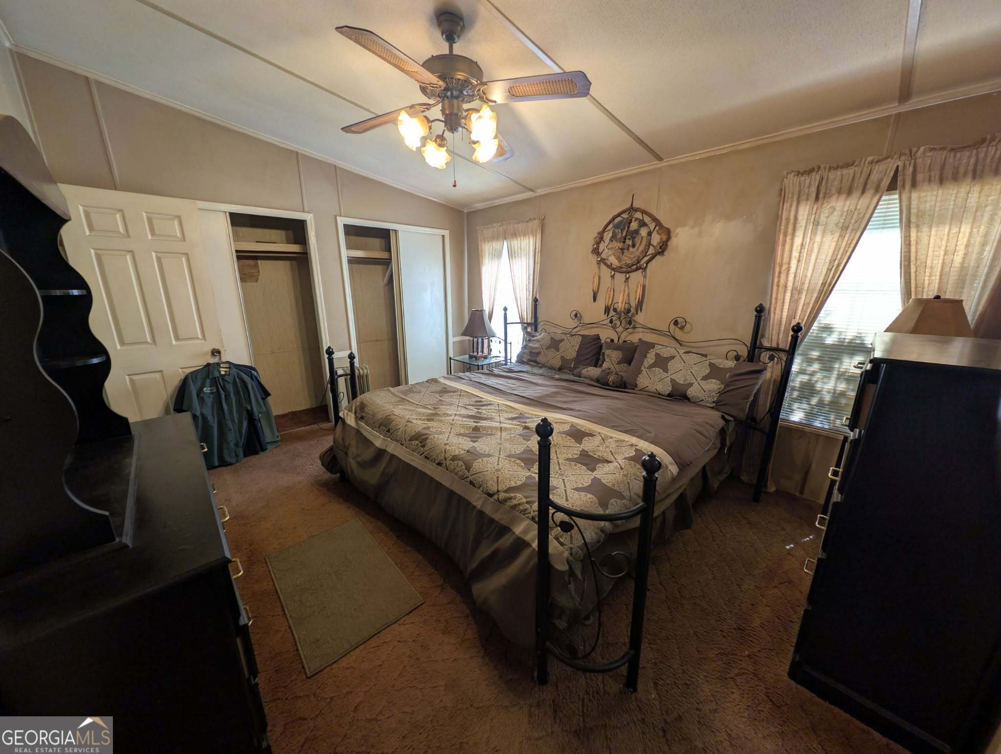 460 Etheridge Mill Road Milner, GA 30257 - Photo 15 of 27 a bed room with a bed mirror and a window