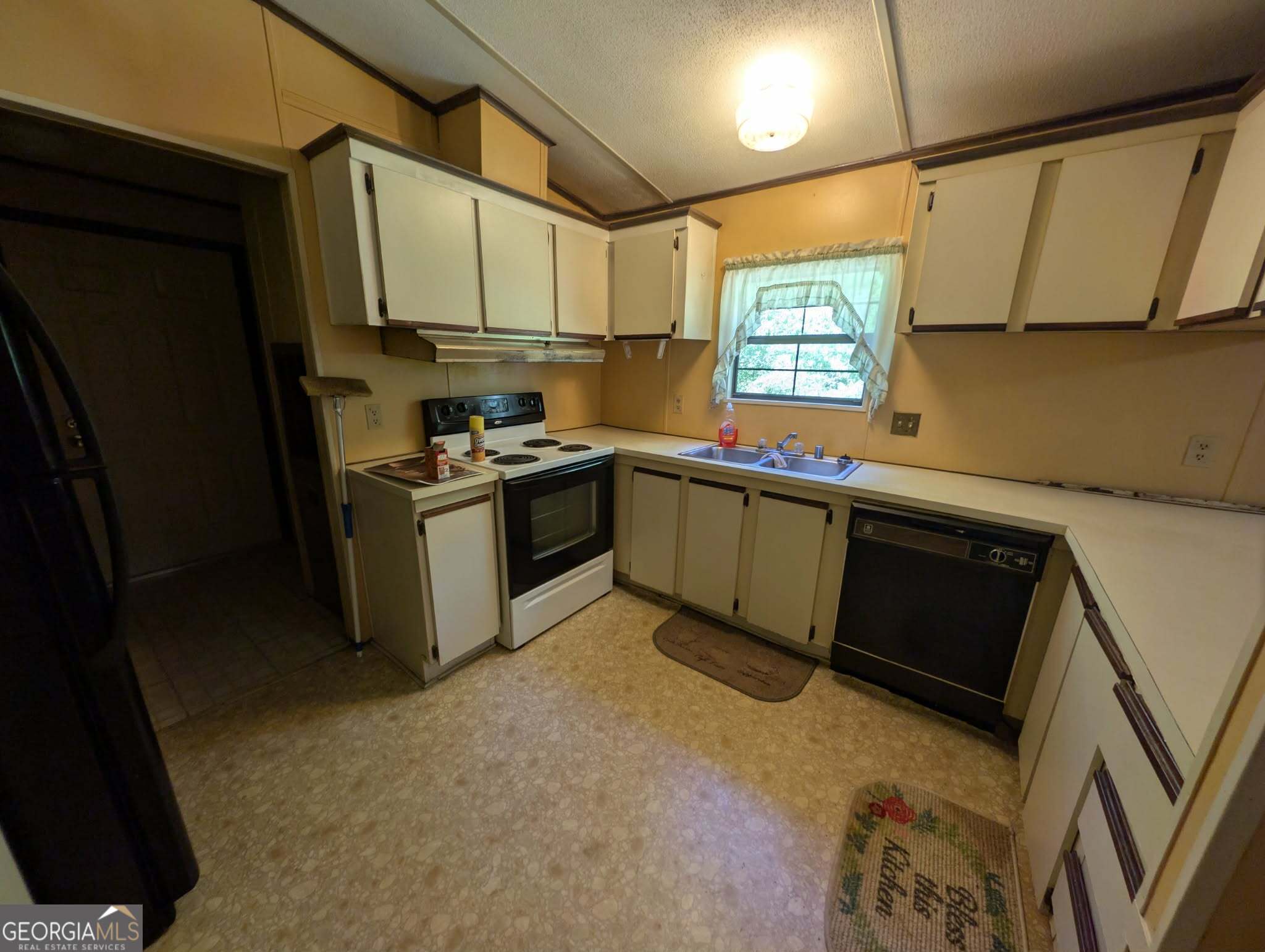 460 Etheridge Mill Road Milner, GA 30257 - Photo 20 of 27 a kitchen with stainless steel appliances granite countertop a sink stove and refrigerator