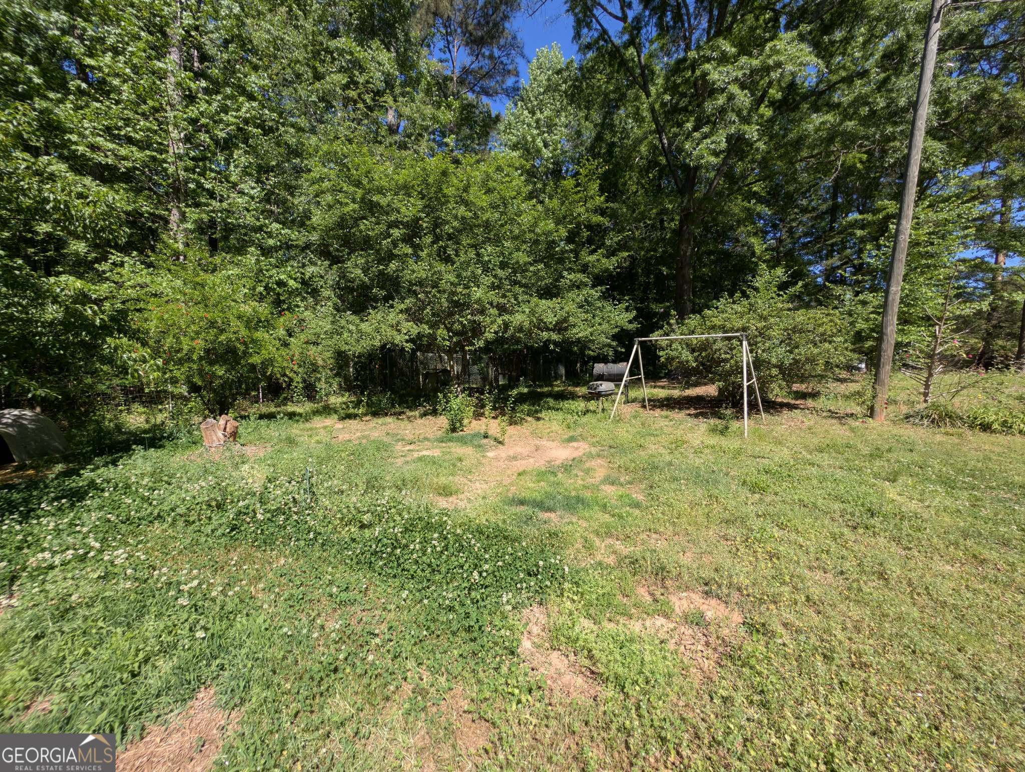 460 Etheridge Mill Road Milner, GA 30257 - Photo 27 of 27 a garden view with a bench