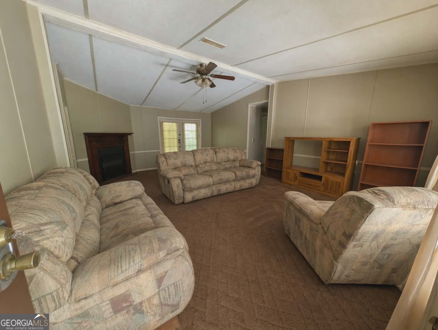 460 Etheridge Mill Road Milner, GA 30257 - Photo 4 of 27 a living room with furniture and a fireplace
