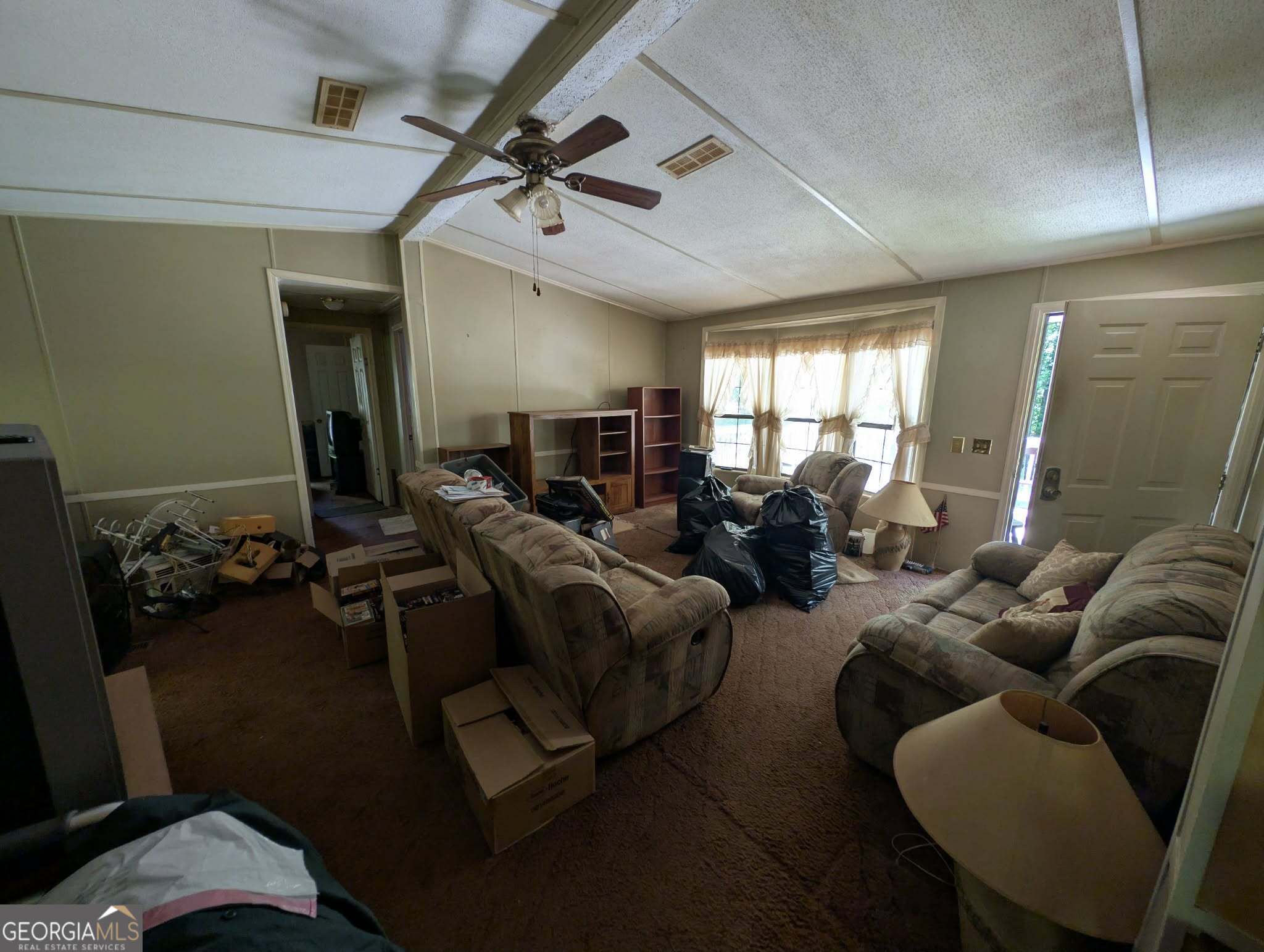 460 Etheridge Mill Road Milner, GA 30257 - Photo 8 of 27 a living room with furniture gym equipment and a window