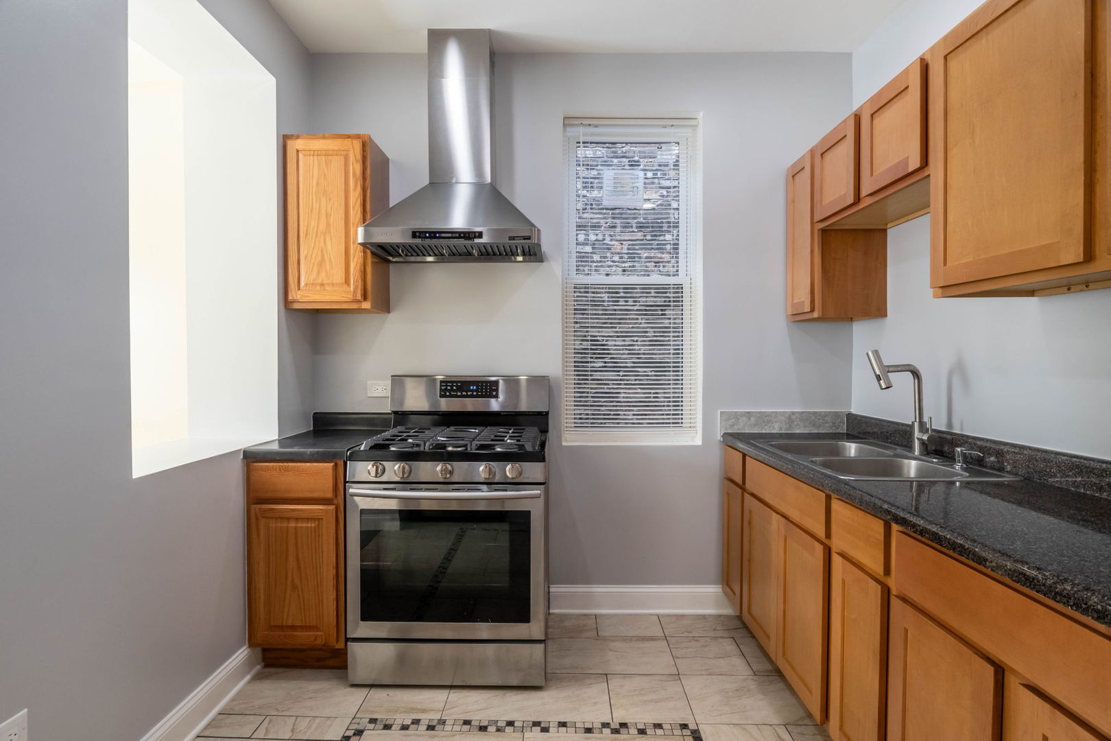 4837 West Monroe Street, Unit 1 Chicago, IL 60644 - Photo 15 of 21 a kitchen with stainless steel appliances a stove a sink and a microwave