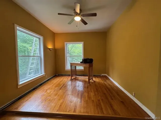 a workspace with wooden floor and a window