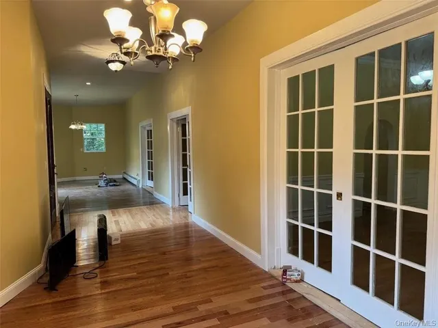a view of a hallway with wooden floor