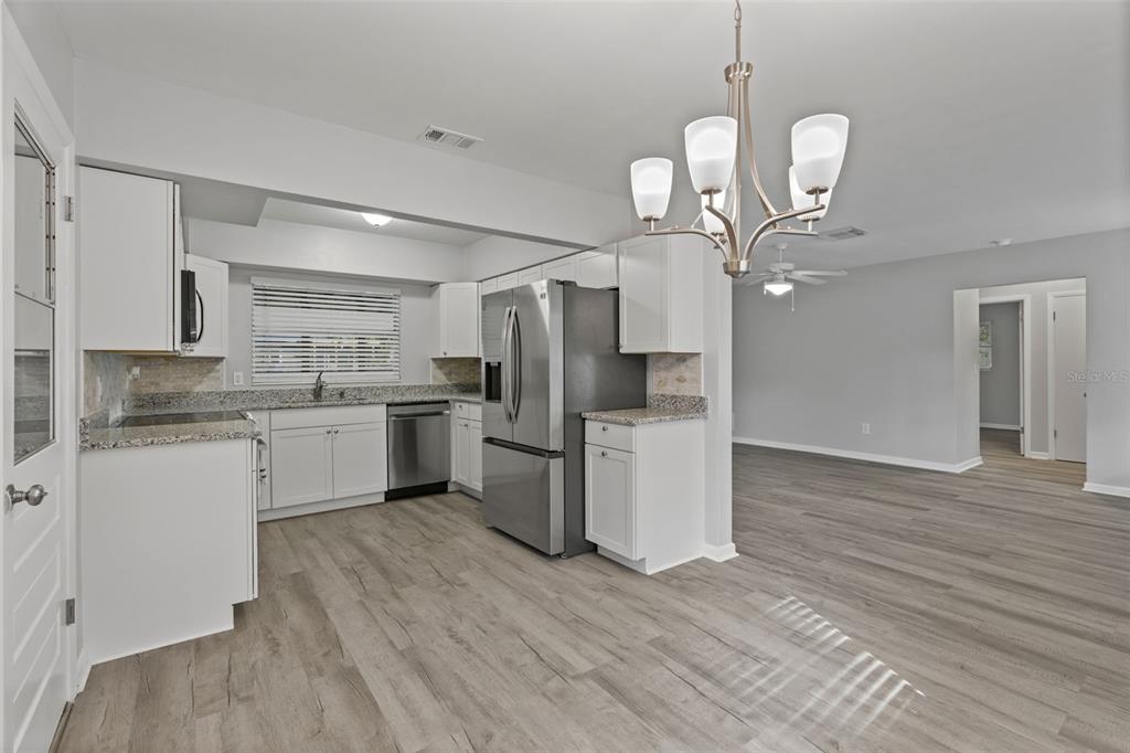 410 Daisy Lane Inverness, FL 34452 - Photo 15 of 37 a kitchen with a refrigerator sink and cabinets