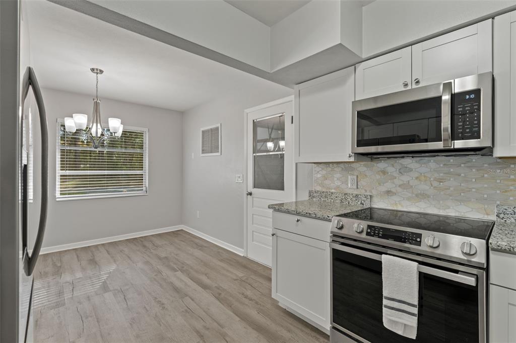 410 Daisy Lane Inverness, FL 34452 - Photo 17 of 37 a kitchen with stainless steel appliances a stove microwave and sink