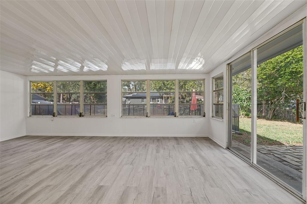 410 Daisy Lane Inverness, FL 34452 - Photo 19 of 37 a view of an empty room with wooden floor and doors