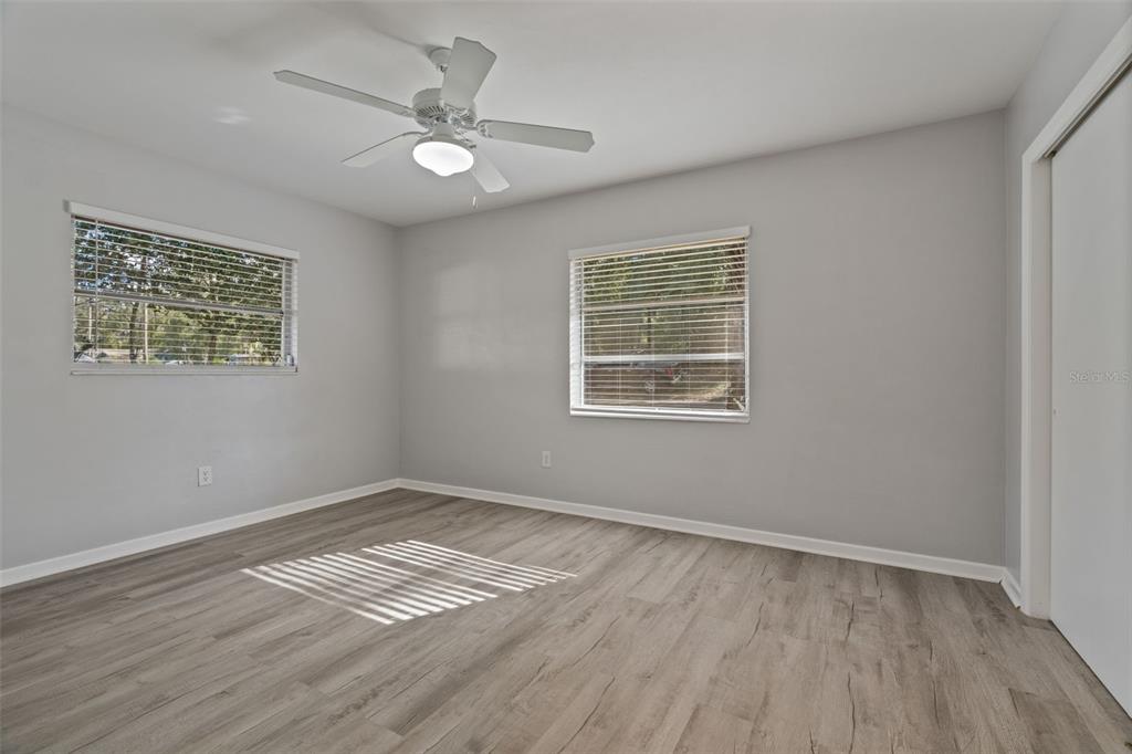 410 Daisy Lane Inverness, FL 34452 - Photo 22 of 37 a view of empty room with wooden floor and fan