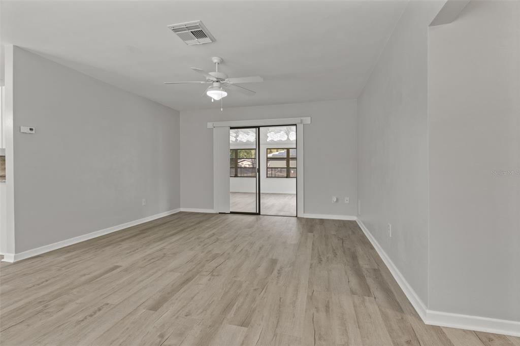 410 Daisy Lane Inverness, FL 34452 - Photo 10 of 37 wooden floor in an empty room with a window