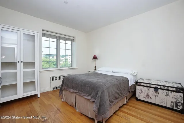 a bedroom with a bed and a tv