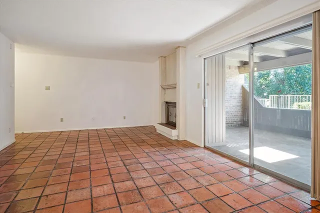 a big room with windows and a fireplace