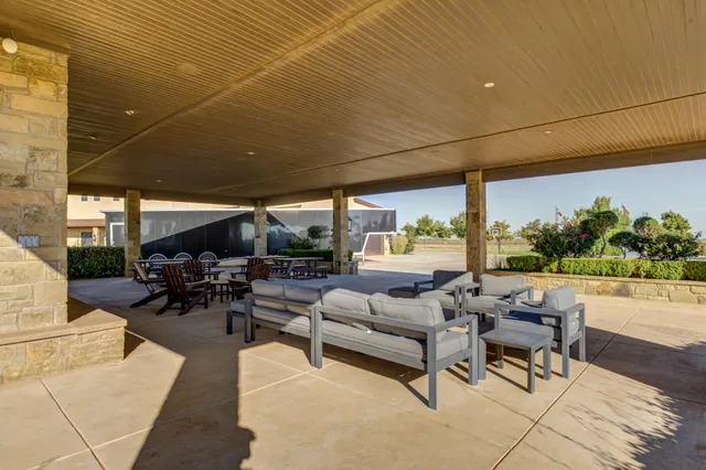 a bathroom with a granite countertop toilet a sink and a mirror