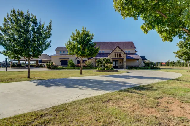 a front view of a house with a yard and a garage