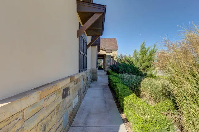 a living room with furniture kitchen view and a chandelier