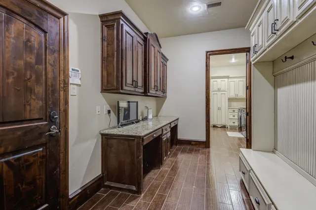 a kitchen with kitchen island granite countertop a stove sink and cabinets
