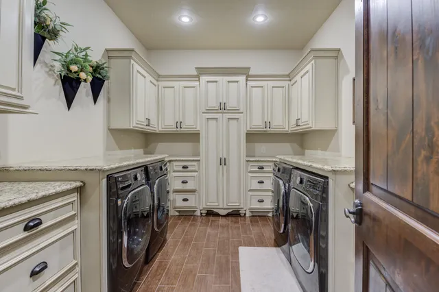 a kitchen with stainless steel appliances granite countertop a sink and a refrigerator