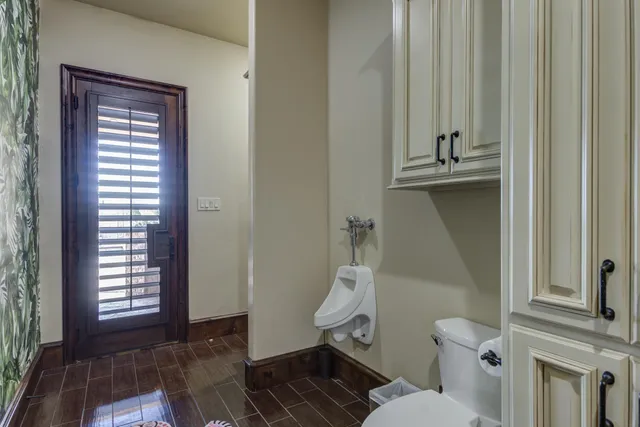 a view of swimming pool with outdoor seating and trees in the background