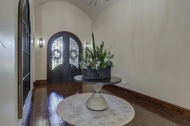 a view of swimming pool with outdoor seating and trees in the background