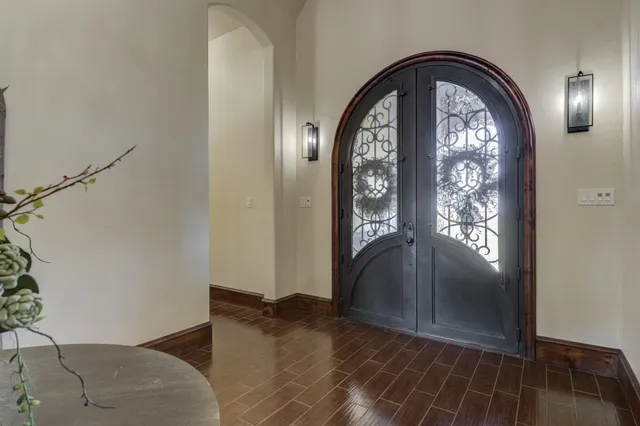 an empty room with wooden floor closet and windows