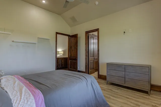 a view of a livingroom and dining room with wooden floor a chandelier