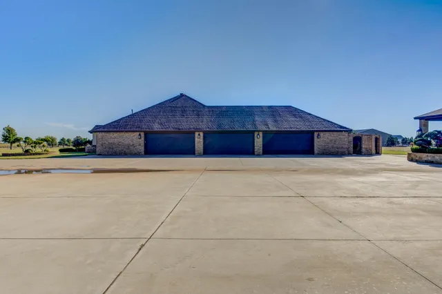 a view of pool with table and chairs under an umbrella
