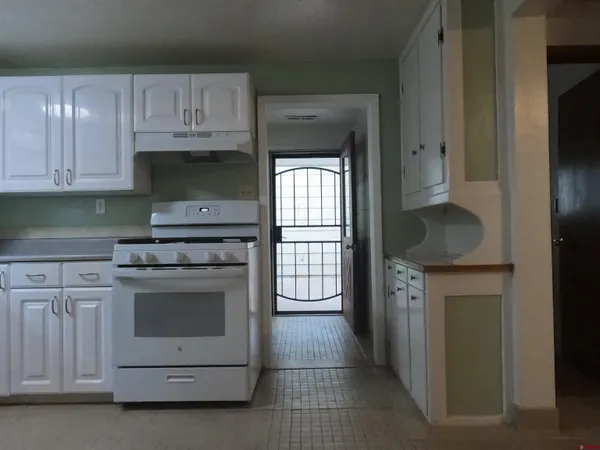 a kitchen with cabinets and appliances