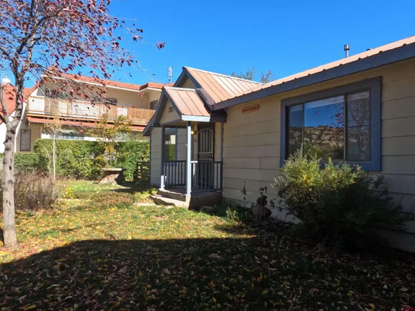 a view of house with backyard and garden