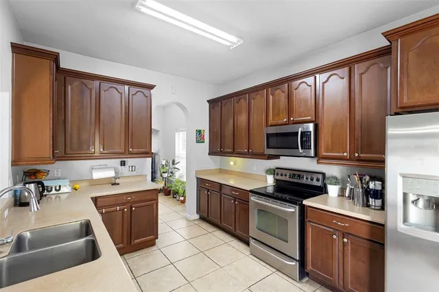 a view of a kitchen with a sink washer and dryer