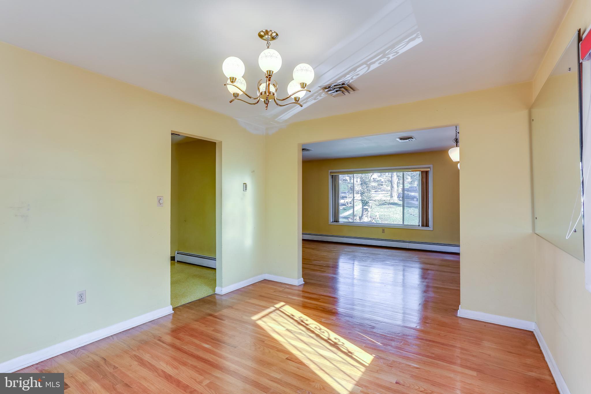2408 Monticello Road Baltimore, MD 21216 - Photo 8 of 27 a view of a room with wooden floor and chandelier