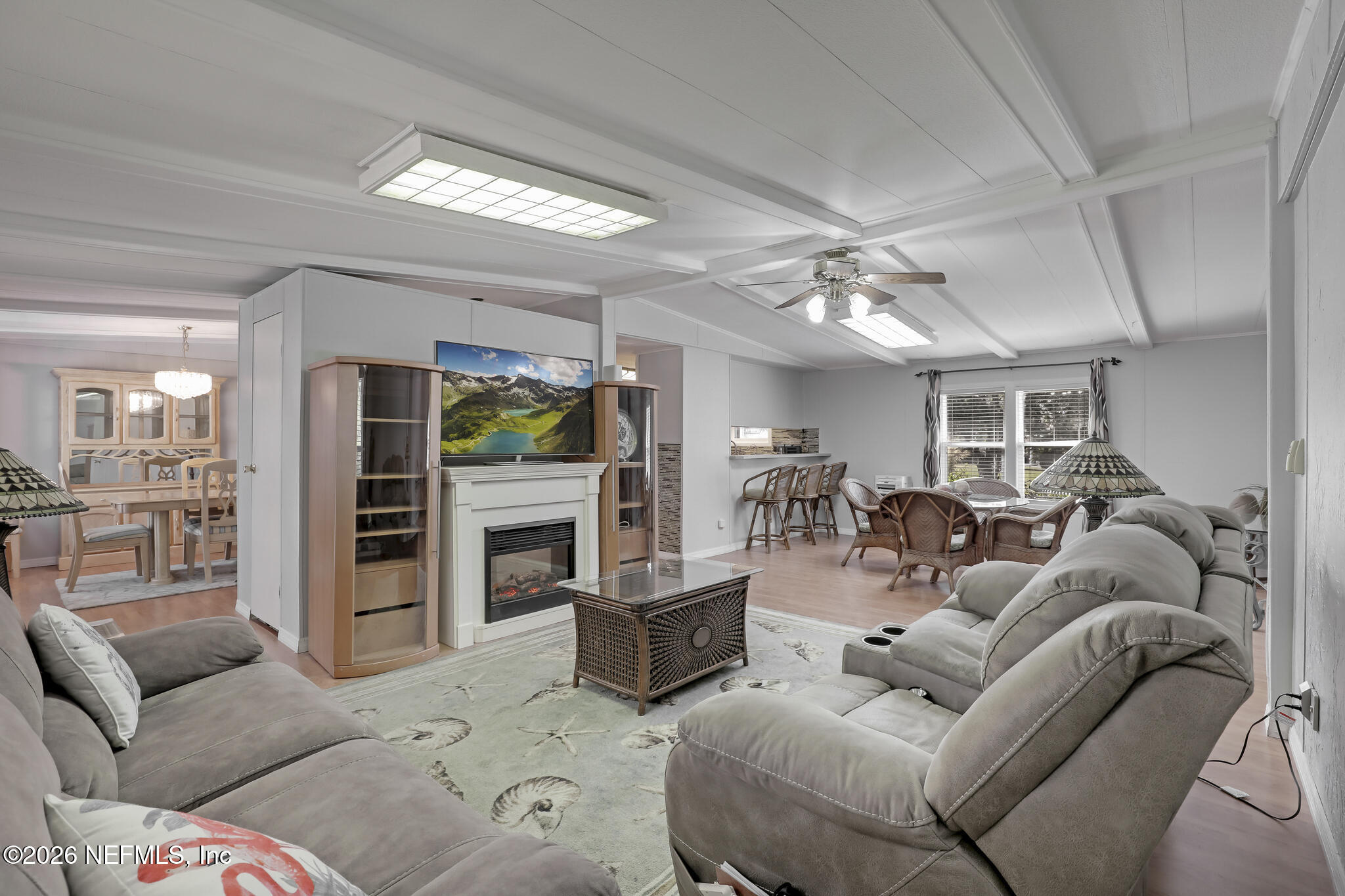 6901 Catlett Road St. Augustine, FL 32095 - Photo 16 of 74 a living room with furniture a fireplace and a flat screen tv