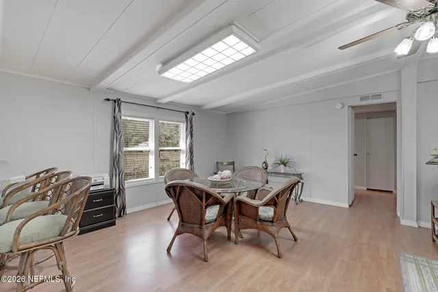 a view of a dining room with furniture window and outside view