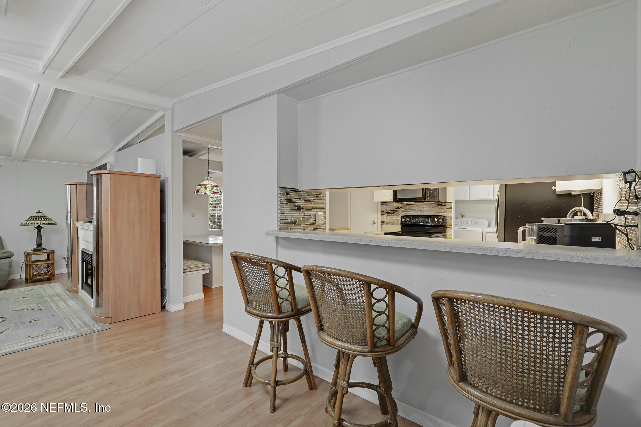 6901 Catlett Road St. Augustine, FL 32095 - Photo 27 of 74 a kitchen with stainless steel appliances a dining table chairs and refrigerator