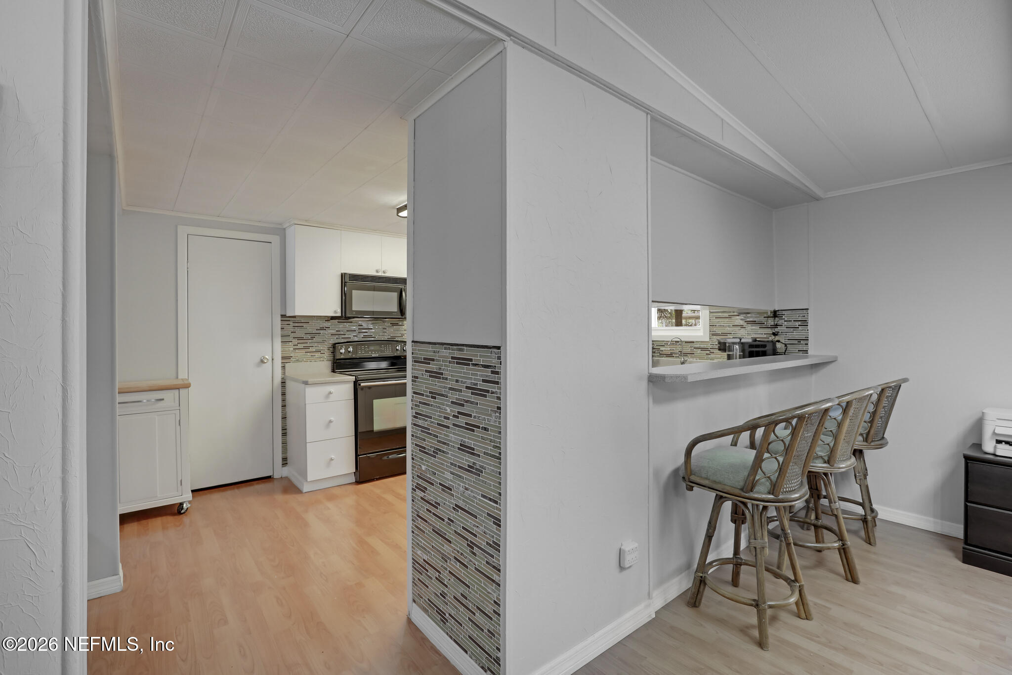 6901 Catlett Road St. Augustine, FL 32095 - Photo 28 of 74 a kitchen with stainless steel appliances kitchen island granite countertop a refrigerator and a stove top oven