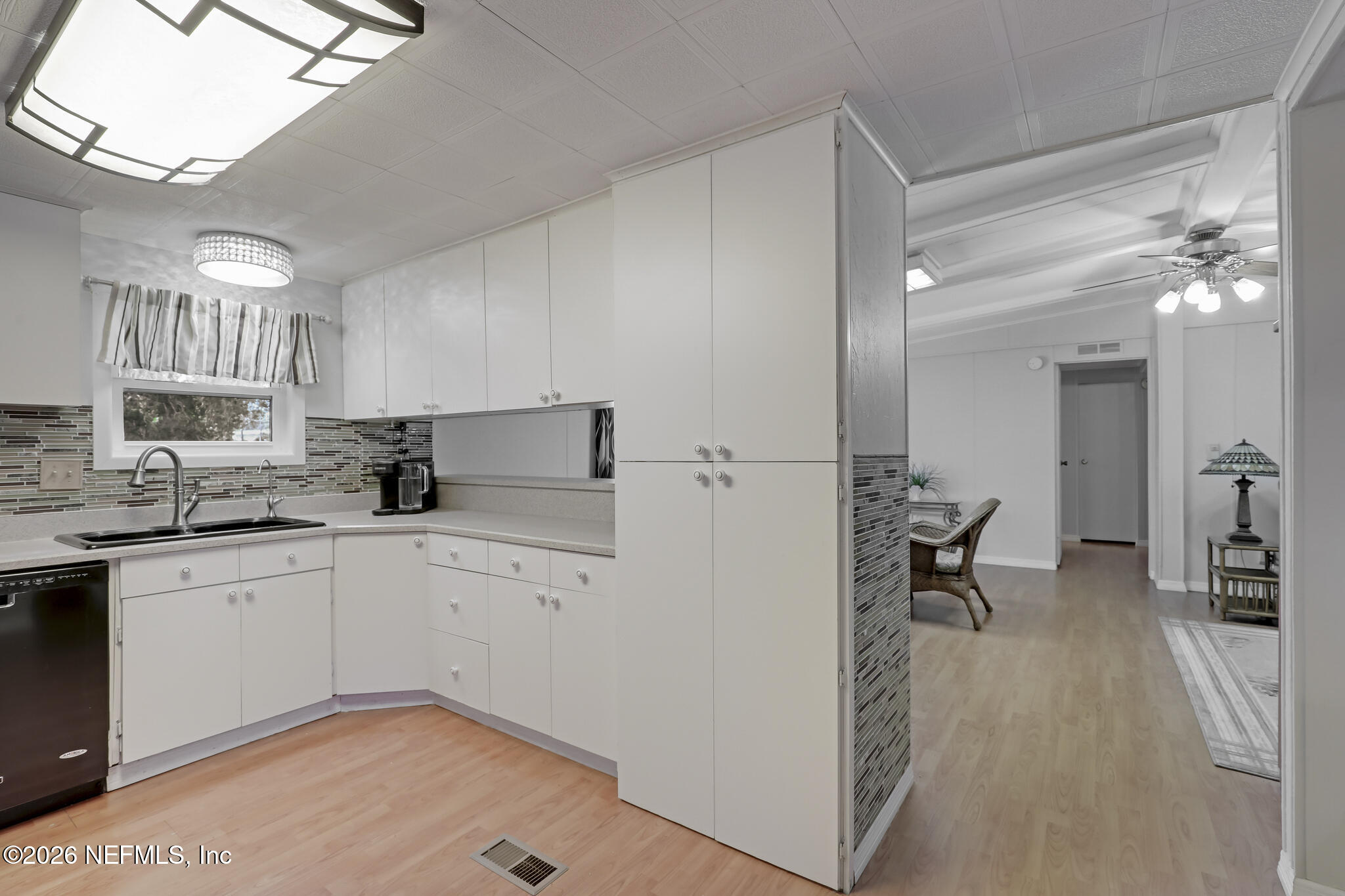 6901 Catlett Road St. Augustine, FL 32095 - Photo 32 of 74 a kitchen with a sink cabinets and window