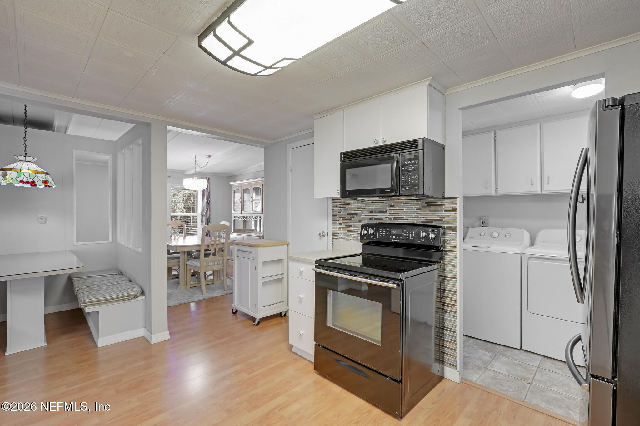 6901 Catlett Road St. Augustine, FL 32095 - Photo 37 of 74 a kitchen with white cabinets and stainless steel appliances