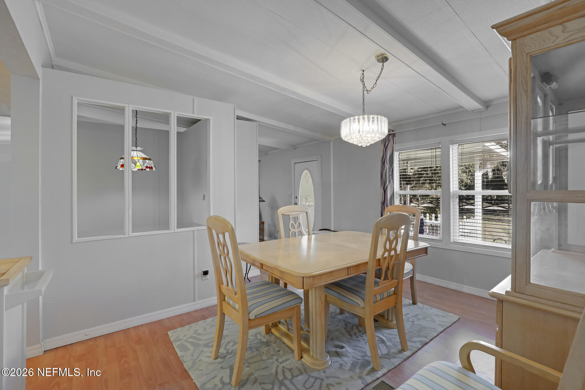 6901 Catlett Road St. Augustine, FL 32095 - Photo 39 of 74 a dining room with furniture a chandelier and wooden floor