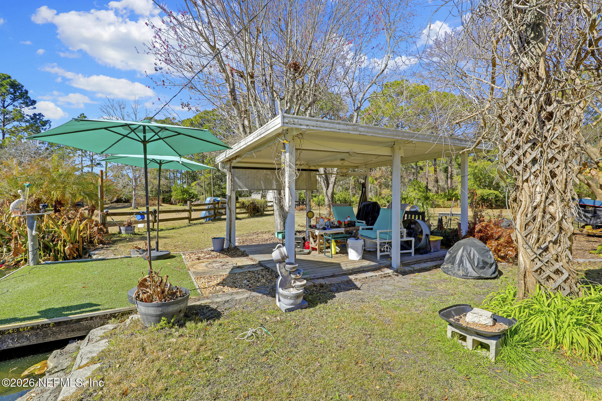6901 Catlett Road St. Augustine, FL 32095 - Photo 57 of 74 a view of a chairs and table in backyard of the house