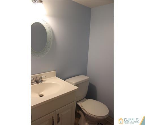 20 Dover Road Colonia, NJ 07067 - Photo 13 of 19 a white toilet sitting next to a bathroom sink