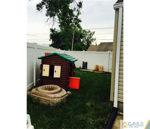 20 Dover Road Colonia, NJ 07067 - Photo 17 of 19 a backyard of a house with table and chairs