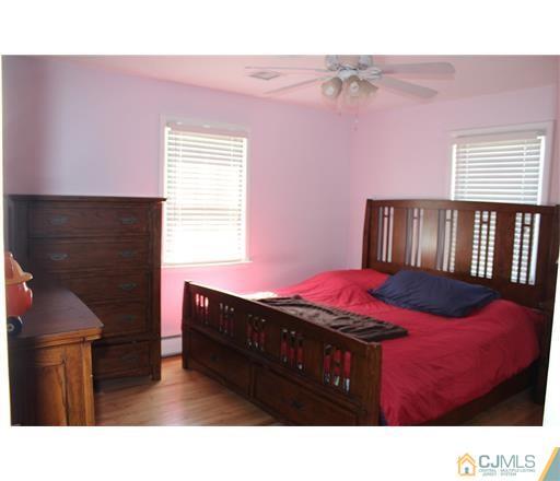 20 Dover Road Colonia, NJ 07067 - Photo 8 of 19 a bedroom with a bed and a fireplace