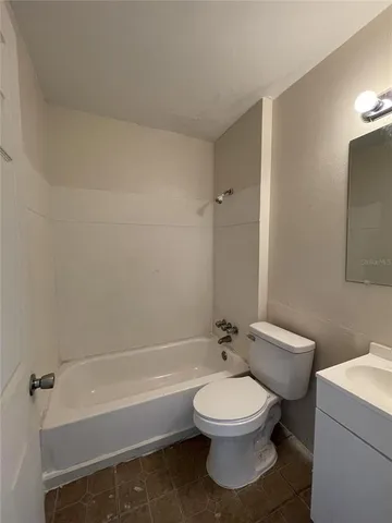 a bathroom with a toilet a sink and bathtub