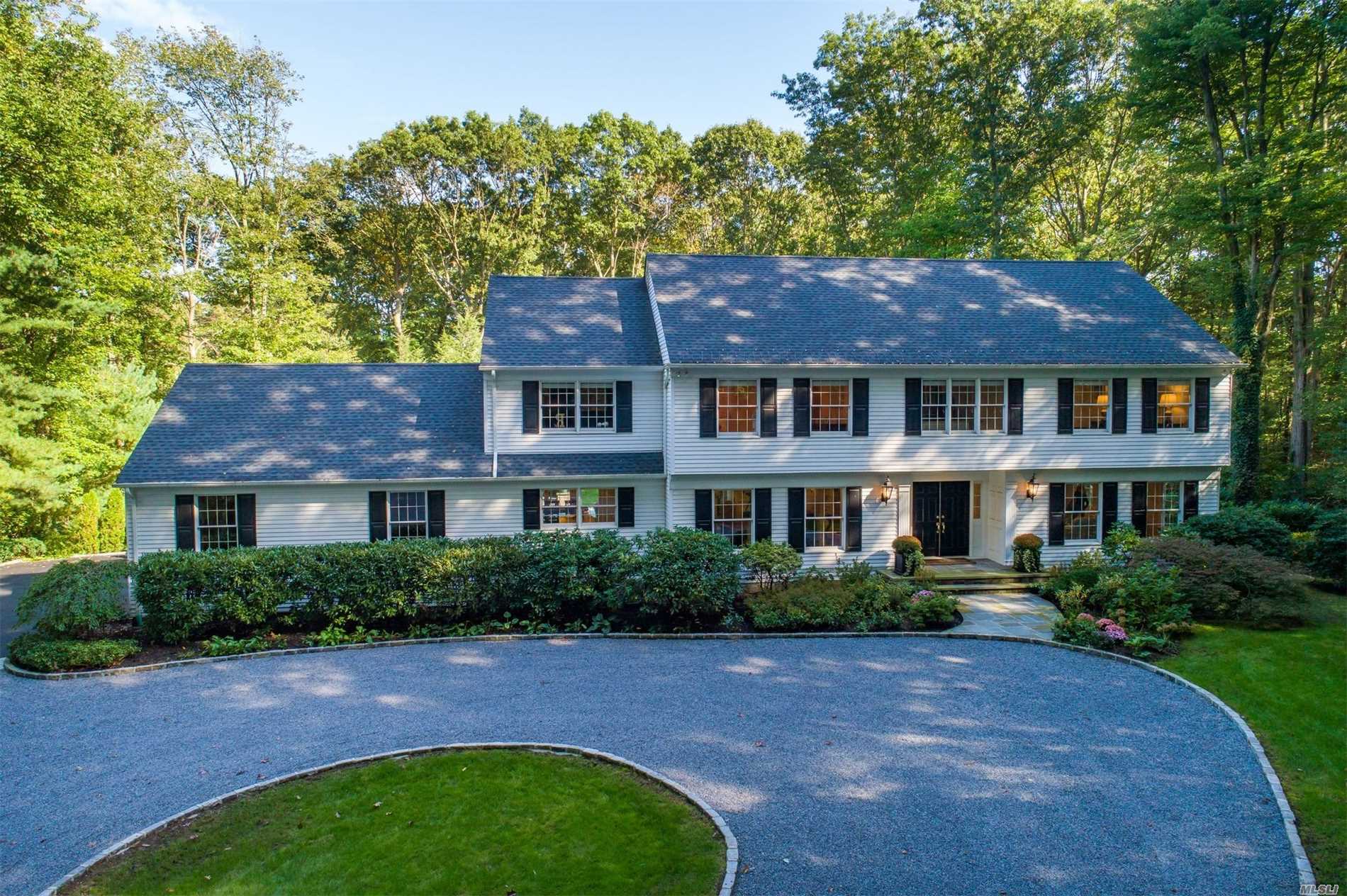 20 Timber Ridge Drive Laurel Hollow, NY 11771 - Photo 1 of 1 a front view of a house with a garden