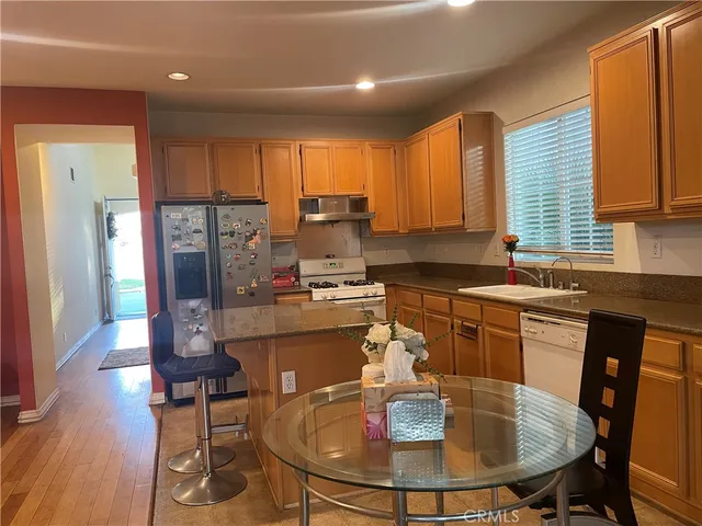 a kitchen with a table chairs sink and cabinets