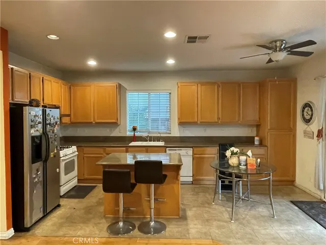 a kitchen with granite countertop lots of counter top space and stainless steel appliances