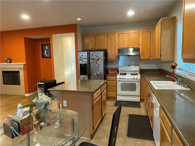 a kitchen with a sink stove and refrigerator